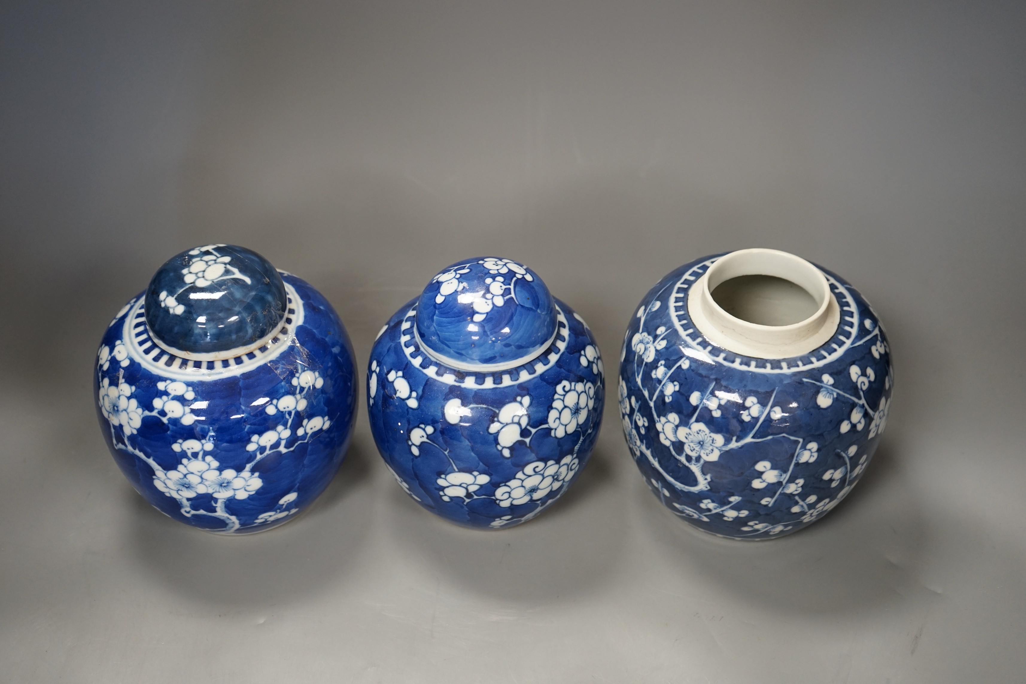 Three 19th century Chinese blue and white 'prunus' jars and two covers, 15cm